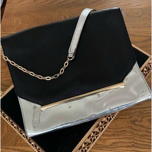Vince Camuto black, metallic silver and gold handbag. Chain strap.